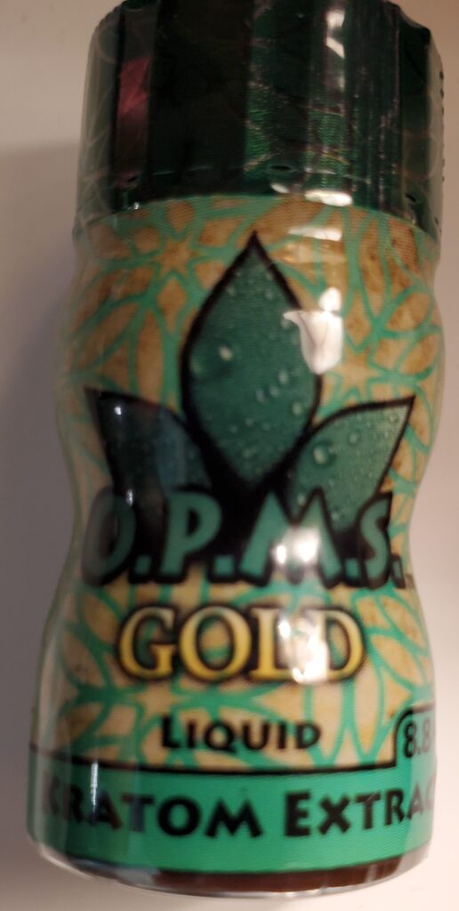 Image is small bottle with a green lid and a yellow/tan label wrapped around it with leaf images and the word O.P.M.S in the middle with the word GOLD under that. Then in smaller font is the word Liquid. On the bottom of the bottle is green background with the word KRATOM EXTRACT.