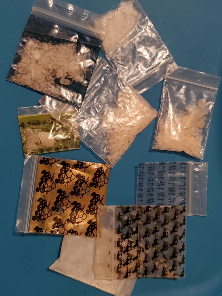 Various small bags containing a crystalline substance that is meth.