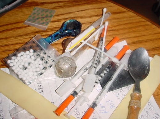 Methamphetamine paraphernalia. Spoon with residue, needles, cotton balls, small baggies, cut straw (tooter), and a band of rubber for tourniquet.